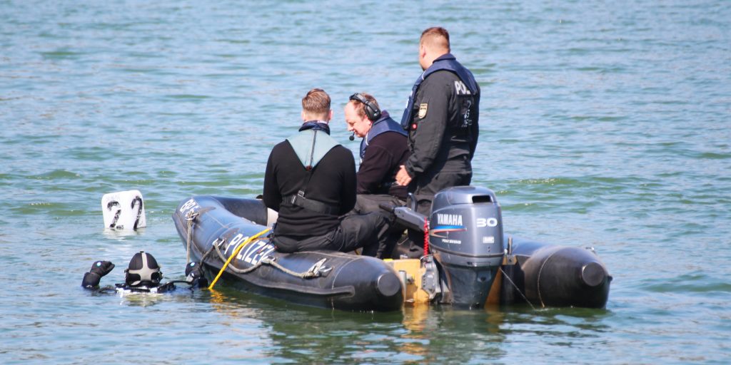 A PADI professional diver helps to assist in a police investigation. This is one of may jobs that involve scuba diving.