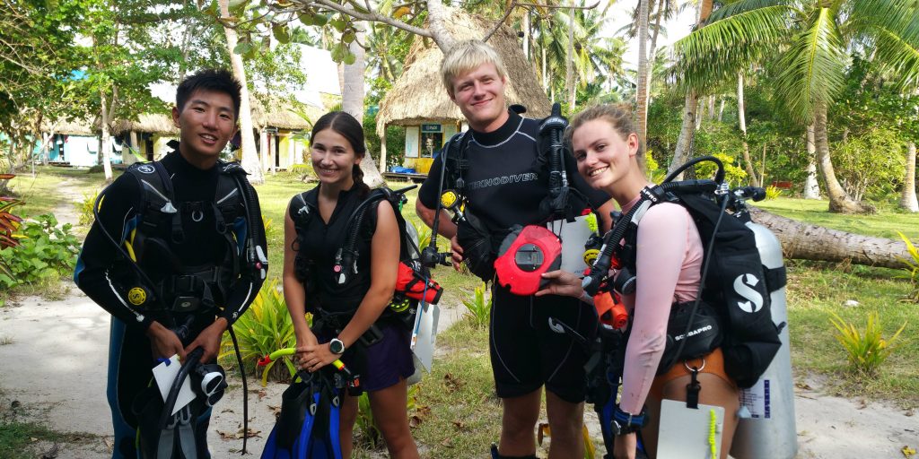 GVI participants in Caqalai prepare to set out on an open water dive. These dives count toward their PADI certifications.