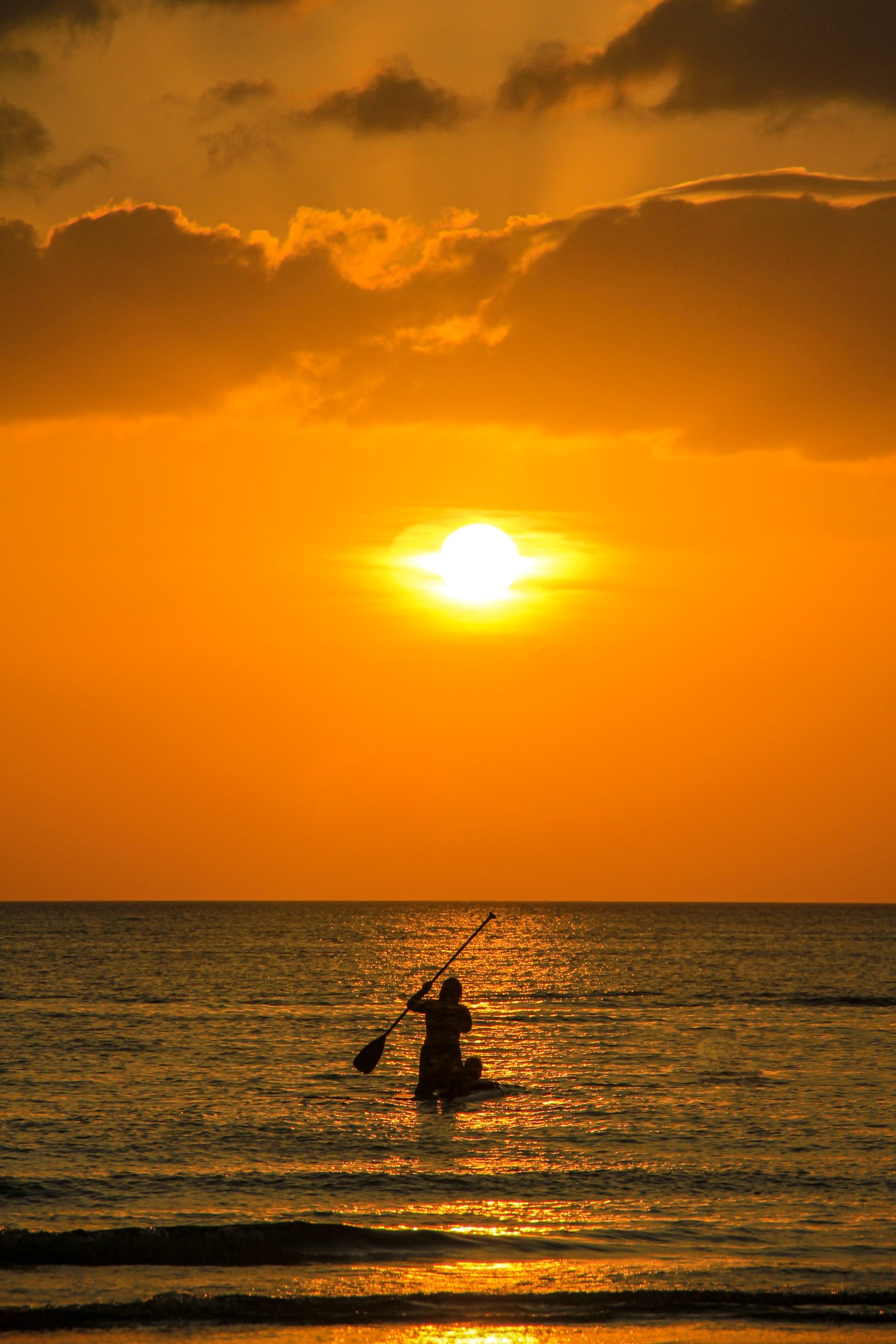 Stand-up paddleboard at sunrise